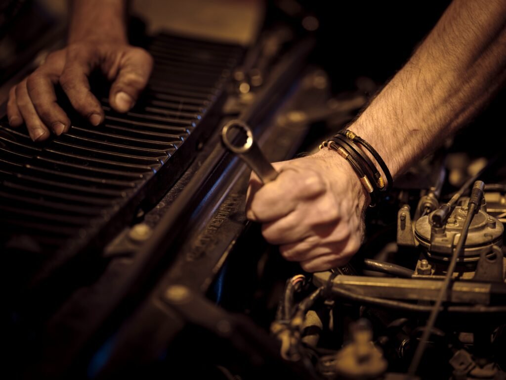 Mechanic tightening a bolt under the bonnet, the kind of small business owner who can get a home loan with an ATO payment plan