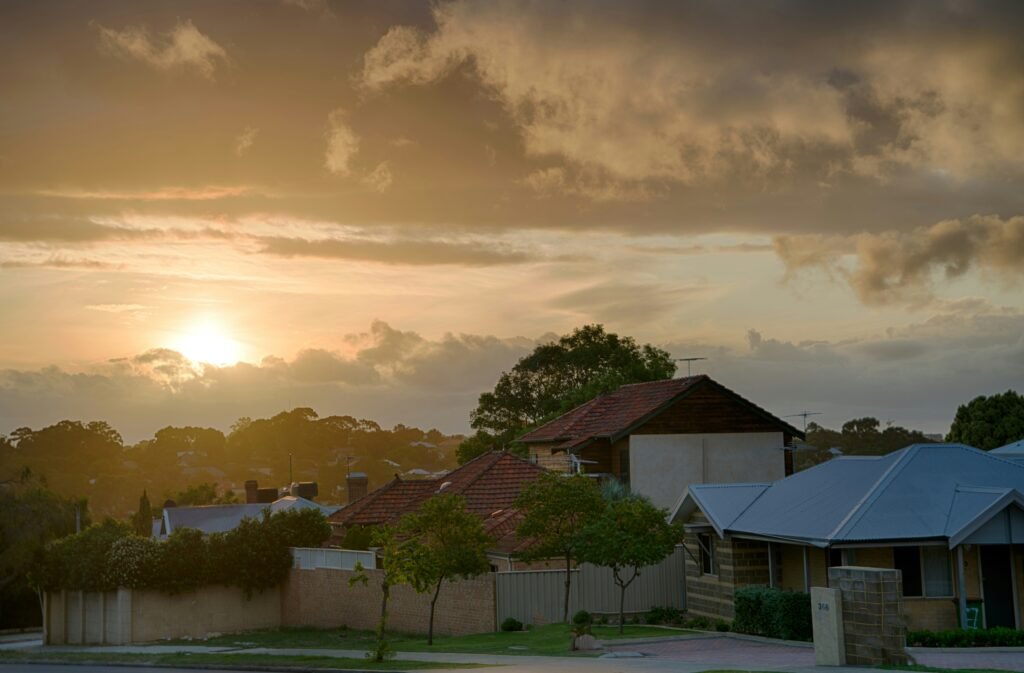 Perth suburban street at sunset with terracotta roofs and a limestone wall, the home to come back to for anyone buying a house in Perth while working in the Pilbara