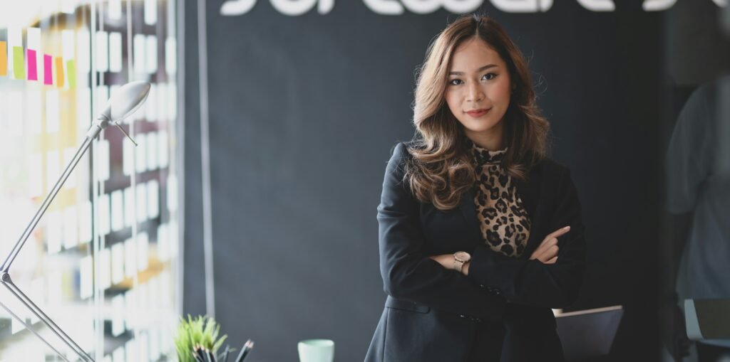 Company director standing in her office with arms crossed, the kind of business owner a home loan for company directors is designed for"