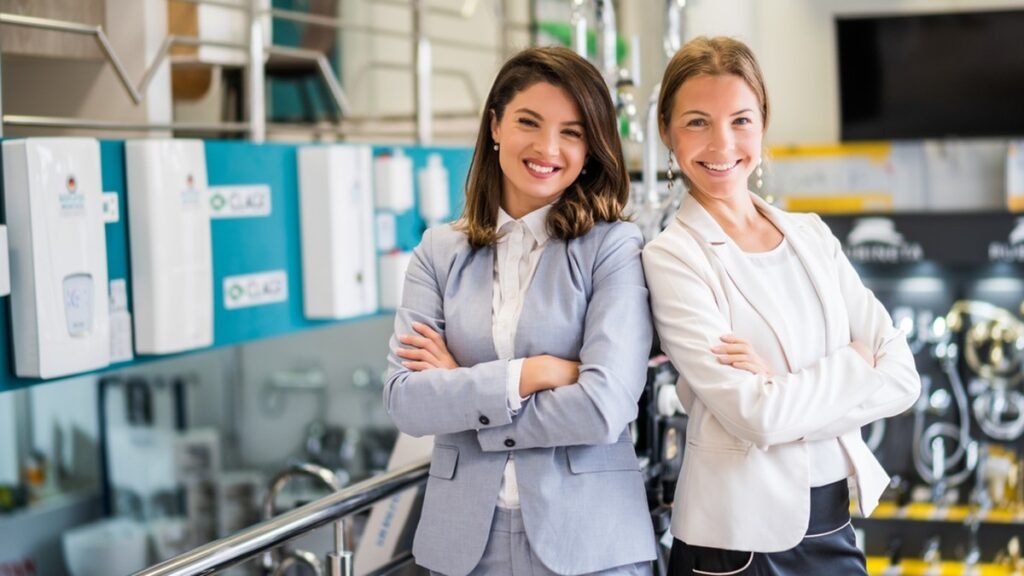 wo business owners standing confidently in their showroom after 12 months trading