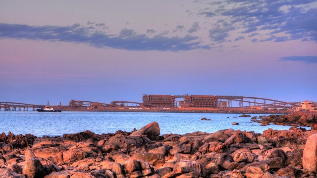 Iron ore loading facility on the WA coast at dusk, supported by local mining services businesses