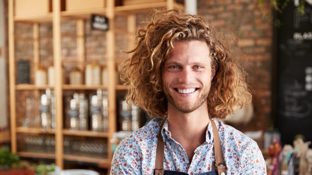 miling small business owner in his shop, staying on top of Payday Super and wages