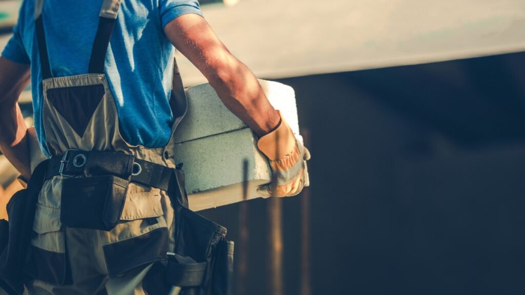 Tradie carrying building materials on site, keeping cash flow moving with a business line of credit